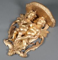 A 19th Century carved wooden and gilt painted wall bracket supported by 2 cherubs 30cm h x 21cm w