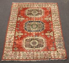 A brown and white ground Afghan rug with 3 octagons to the centre 203cm x 161cm Heavily mothed and
