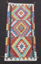 A yellow turquoise and brown ground Chobi Kilim runner 147cm x 66cm