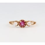A yellow metal ruby and diamond ring, the centre stone 0.25ct, the 2 diamonds 0.10ct each, 1.8