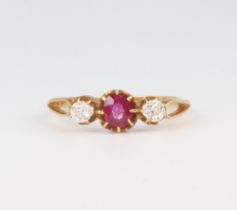 A yellow metal ruby and diamond ring, the centre stone 0.25ct, the 2 diamonds 0.10ct each, 1.8