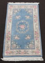 A blue and floral patterned Chinese rug 160cm x 92cm Slight stains in places