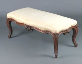 A Victorian carved rosewood show frame stool of serpentine outline, raised on cabriole supports 43cm