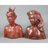A Balinese carved hardwood portrait bust of a lady and gentleman, the base marked A Fatimah Bali