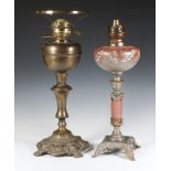 A Victorian opaque glass oil lamp reservoir raised on a marble effect and silvered metal column 45cm