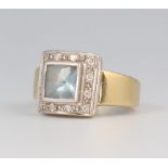 A yellow metal square aquamarine and diamond cocktail ring, the centre stone approx. 1ct, surrounded