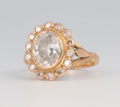 A yellow metal 18ct diamond cluster ring, the centre stone approx. 1.5ct surrounded by 14