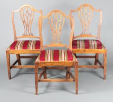 A set of 3 19th Century oak Hepplewhite style camel back dining chairs with pierced slat backs and
