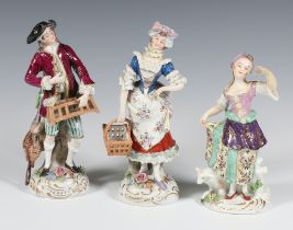 A pair of 20th Century Sitzendorf figures of street sellers raised on rococo bases 17cm, ditto