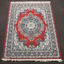 A red, blue and white ground Persian style machine made rug with central medallion 228cm x 170cm