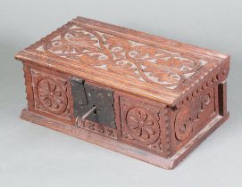 A Victorian rectangular carved oak trinket box in the form of a coffer with iron lock, the front