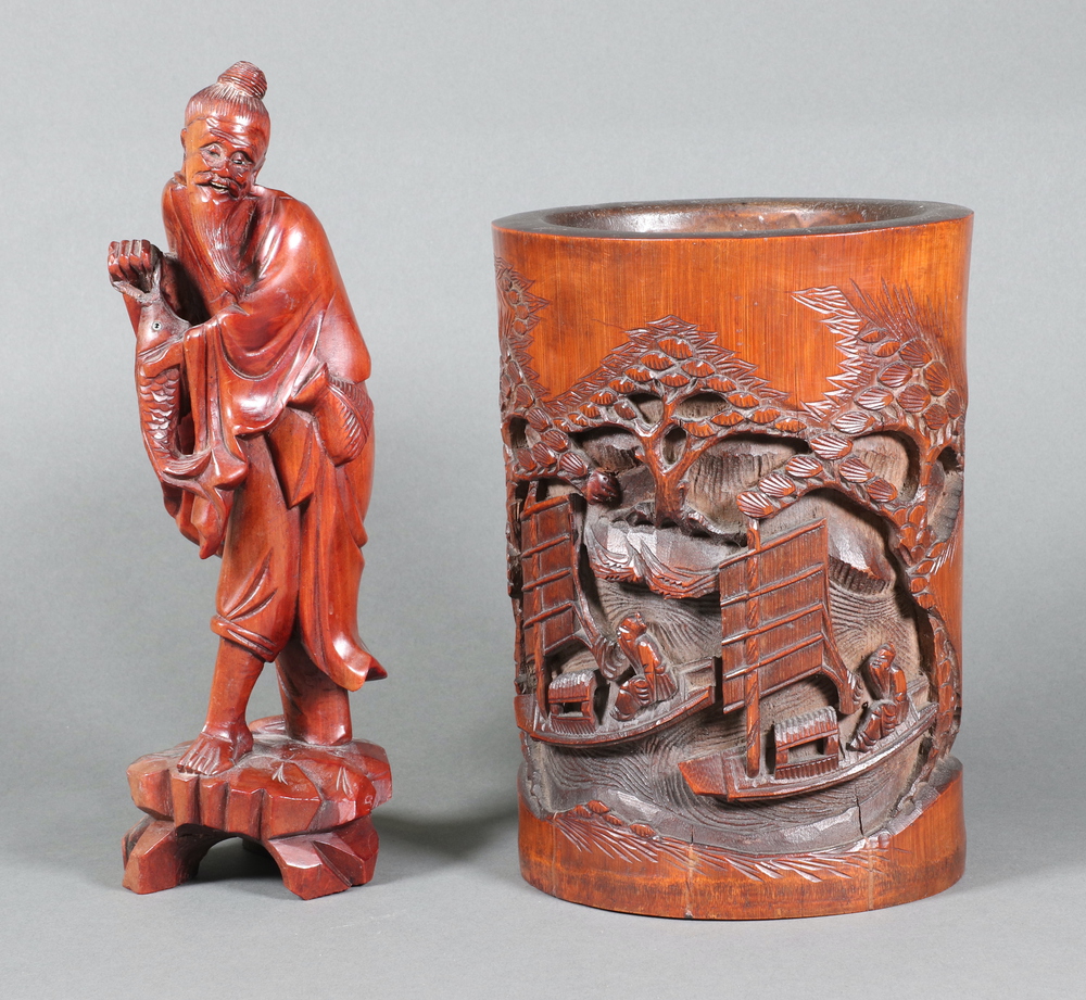 A Chinese carved hardwood figure of a standing fisherman 24cm, a bamboo vase with carved