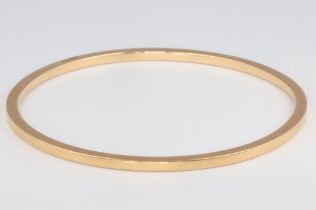 A yellow metal (acid tested as at least 14ct) plain bangle, 21.8 grams 6cm diam.