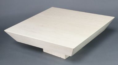 A Travertine veined square marble coffee table, raised on a cubic plinth, by Stone International