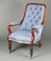 A William IV mahogany open arm chair upholstered in blue buttoned material, raised on cabriole