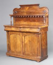 A Victorian rosewood chiffonier the raised back fitted a shelf, the base 2 secret drawers above