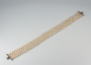 A white metal seed pearl bracelet with white metal diamond set clasp 16cm