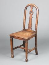 A 1920's Liberty style oak slat back hall chair with solid seat, raised on square tapered
