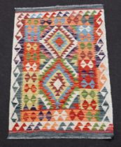 A white, brown and green ground Chobi Kilim, having diamonds to the centre and overall geometric