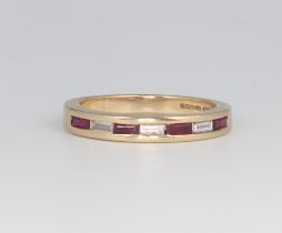 A 9ct yellow gold baguette cut ruby and diamond ring comprising 4 rubies and 3 diamonds, each approx