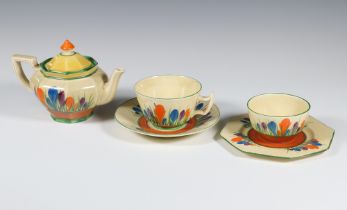 A Clarice Cliff Bizarre Crocus pattern teapot, tea cup and saucer, sugar bowl and octagonal