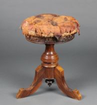 A Victorian walnut revolving adjustable piano stool, seat upholstered in buttoned leather, on a