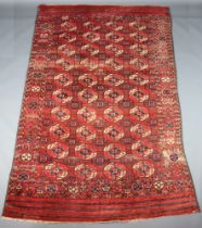 A red and blue ground Bokhara rug with 38 octagons to the centre 302cm x 184cm In heavy wear,