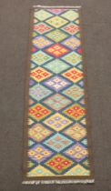 A blue, black and green ground Maimana Kilim runner with overall diamond design 210cm x 63cm