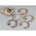Five various "Benin" bronze bangles together with a shackle bangle