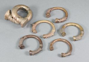 Five various "Benin" bronze bangles together with a shackle bangle