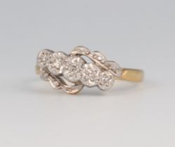 A yellow metal 18ct 5 stone diamond ring, approx. 0.05ct, 3.1 grams, size M 1/2