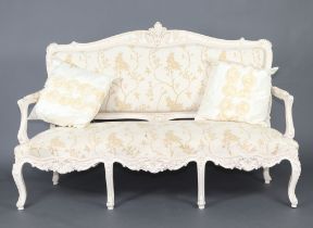 A 20th Century white painted Louis style salon suite comprising open arm sofa of serpentine outline,