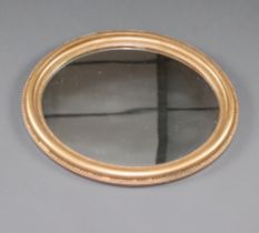 A 19th Century oval plate wall mirror contained in a decorative gilt painted frame 58cm h x 50cm w