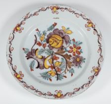 An 18th Century Continental Delft plate decorated with stylised flowers 35cm There is extensive