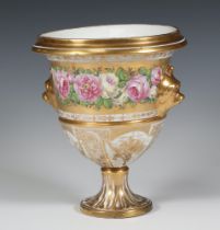 A 19th Century gilt vase with mask handles and bands of flowers decorated with panels of instruments