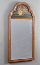 A Georgian style rectangular plate mirror contained in a walnut arch shaped frame, upper panel