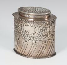 A George V repousse silver oval tea caddy decorated with demi-fluted and floral decoration Sheffield