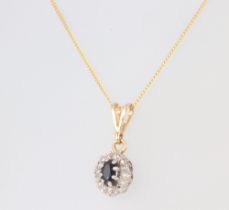 A yellow metal 9ct necklace with diamond and sapphire pendant 1.6grams, 44cm