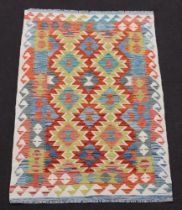 A tan, turquoise and green ground Chobi Kilim with overall geometric design 150cm x 100cm
