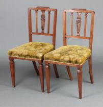 A pair of Edwardian, Georgian style stick and rail back bedroom chairs with over stuffed seats,