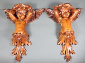 A pair of 19th Century carved lime wood wall brackets in the form of cherubs 42cm x 30cm One has