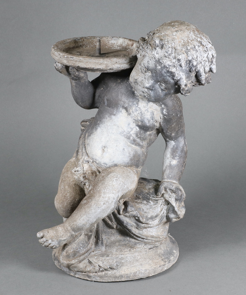 A 19th/20th Century cast lead garden fountain in the form of a seated cherub supporting a saucer