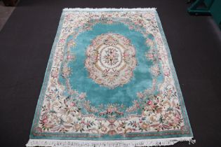 A green and floral patterned Chinese carpet with central medallion 374cm x 277cm Some very light