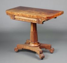 A William IV bleached mahogany pedestal card table raised on an octagonal column with fluted
