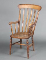 A Victorian elm and beech Windsor stick and bar back kitchen carver chair with solid elm seat,