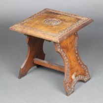 An Eastern carved hardwood square table, the centre with armorial, blind fret work decoration,