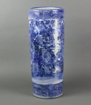 An early 20th Century Japanese transfer print blue and white cylindrical stick stand decorated