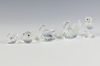 A Swarovski Crystal figure of a swan 5cm, ditto 4cm, another 3cm, a blow fish 5cm and an owl 5cm,