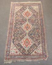 A blue, white and orange ground Persian rug with 3 diamond medallions to the centre 244cm x 135cm