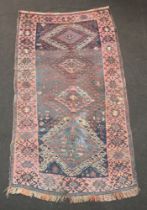 A blue and red Afghan rug with 4 diamonds to the centre 188cm x 103cm